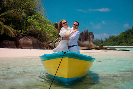 Two lovers and a boat on the paradise Seychellesの写真素材