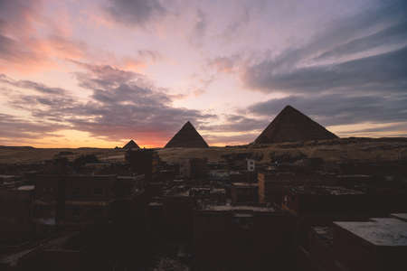 Sunset View to the One of the Wonders of the Ancient World - Great Pyramids of Giza with Colorful...