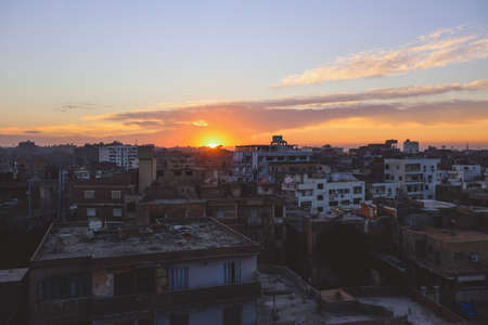 Sunset Cityscape View to the Giza City with the Colorful Sky and Local Buildings, Egyptの写真素材
