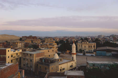 Sunset Cityscape View to the Giza City with the Colorful Sky and Local Buildings, Egyptの写真素材