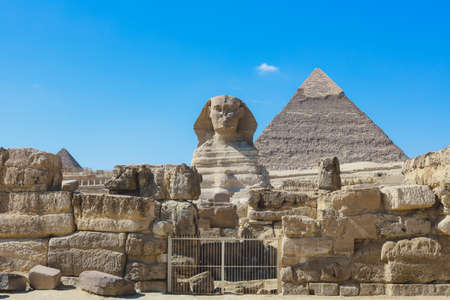 Main View to the Great Sphinx of Giza, is a giant limestone statue with the Great Pyramid in Background in Giza, Egyptの写真素材
