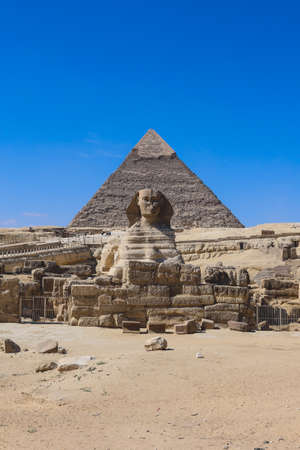 Main View to the Great Sphinx of Giza, is a giant limestone statue with the Great Pyramid in Background in Giza, Egyptの写真素材