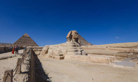 Main View to the Great Sphinx of Giza, is a giant limestone statue with the Great Pyramid in Background in Giza, Egyptの写真素材