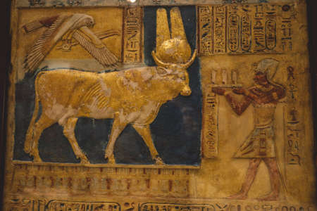 Cairo, Egypt - November 02, 2021: Stone Statue and Golden Painting of Ancient Egyptian Hathor...