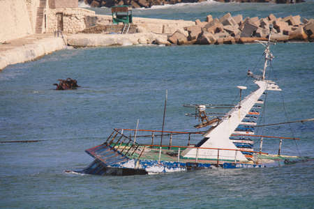 Old Rusted Boats in Blue Water of Alexandria Harbor, Egyptの写真素材