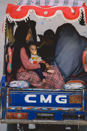 Siwa, Egypt - November 03, 2021: Local Egyptian Families with Children riding on the Bikes through...