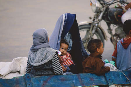 Siwa, Egypt - November 03, 2021: Local Egyptian Families: Men, Women, Children walking on the Siwa...