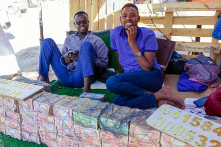 Hargeysa, Somaliland - November 10, 2019: Money Sellers with the selling Meshes of Colorful Money on the Streetのeditorial素材