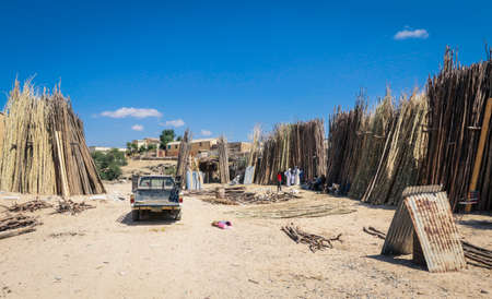 Keren, Eritrea - November 03, 2019: Wood Sticks Seller on the Local Wood Marketのeditorial素材