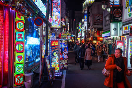 Tokyo, Japan - January 08, 2020: Tourists and Local People walking on the Beautiful Tokyo street among passing Cars in the Night timeのeditorial素材