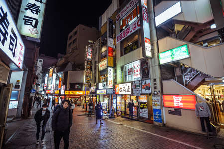 Tokyo, Japan - January 08, 2020: Tourists and Local People walking on the Beautiful Tokyo street among passing Cars in the Night timeのeditorial素材