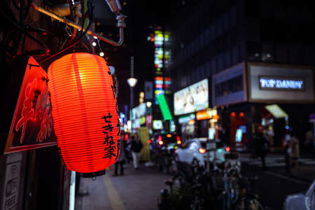 Tokyo, Japan - January 08, 2020: Tourists and Local People walking on the Beautiful Tokyo street among passing Cars in the Night timeのeditorial素材