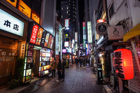 Tokyo, Japan - January 08, 2020: Tourists and Local People walking on the Beautiful Tokyo street among passing Cars in the Night timeのeditorial素材