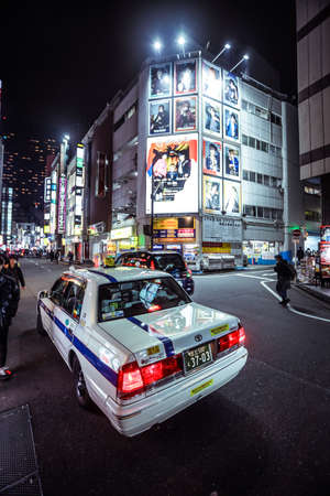 Tokyo, Japan - January 08, 2020: Japanese Cars and Taxi on the Illuminated Night Tokyo road