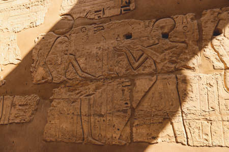 View to an Ancient Egyptian Hieroglyphic Drawing on the wall of the Karnak Temple Complex near Luxor, Egyptの写真素材