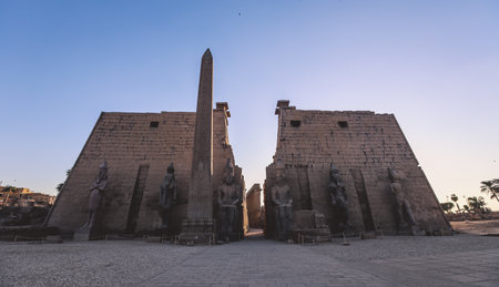 Sunset View to the Illuminated Stone Statues of the large Ancient Egyptian temple in Luxor, Egyptの写真素材