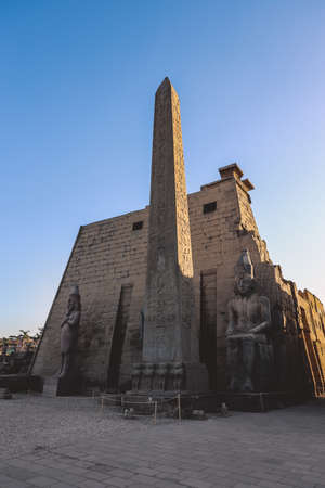 Sunset View to the Illuminated Stone Statues of the large Ancient Egyptian temple in Luxor, Egyptの写真素材
