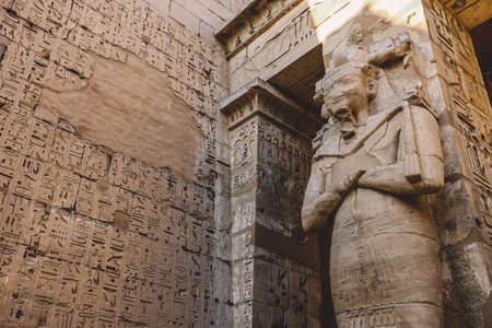 Ancient Egyptian Statues of the Medinet Habu, Mortuary Temple of Ramesses III, near the Luxor, Egypt
