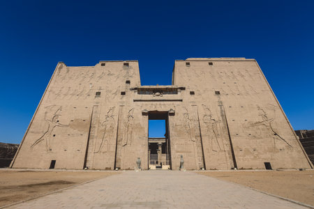 View to the main entrance of an Ancient Egyptian Edfu Temple showing the first pylon in the Sunny Day, Egyptの写真素材