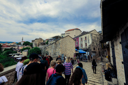 Mostar, Bosnia and Herzegovina - May 12, 2022: Old Town in city center of Mostar with the Colorful Traditional Souvenirs with Walking Touristsのeditorial素材