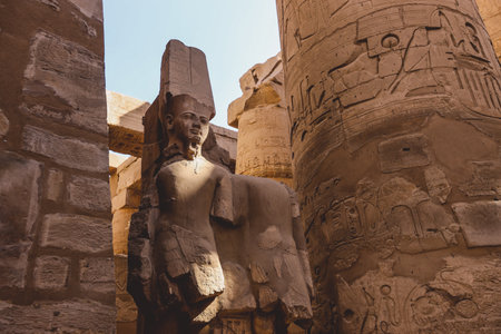 Ancient Sandstone Ruins of Old  Egyptian God in the Karnak Temple Complex near Luxor, Egypt