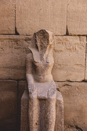 Ancient Sandstone Ruins of Old  Egyptian God in the Karnak Temple Complex near Luxor, Egypt