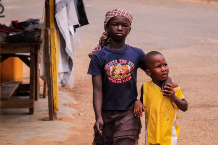 Kumasi, Ghana - April 04, 2022: African playing Children on the Village Street