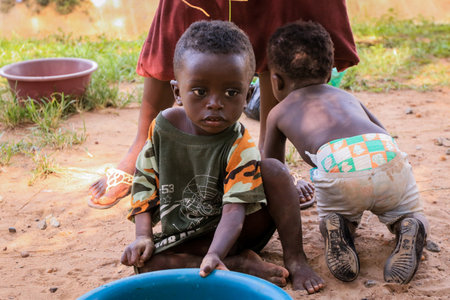 Kumasi, Ghana - April 04, 2022: African playing Children on the Village Streetのeditorial素材