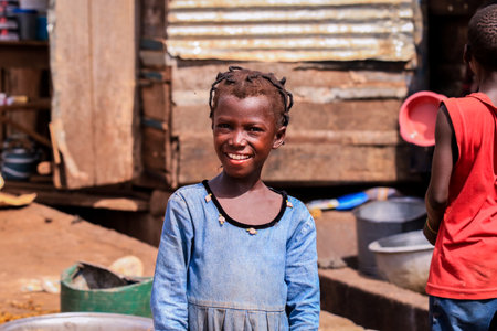 Kumasi, Ghana - April 04, 2022: African playing Children on the Village Streetのeditorial素材