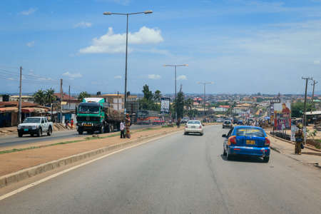 Kumasi, Ghana - April 06, 2022: Crowded African Road with Local Ghana People in Kumasi cityの写真素材