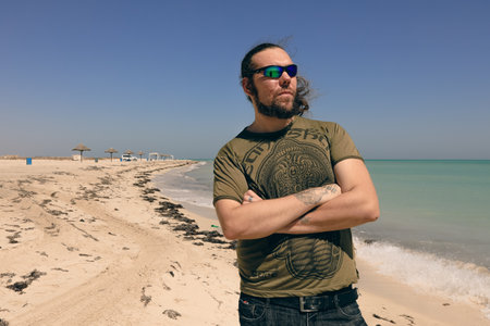 White Tall Man Tourist on the Sandy Beach of the Persian Gulf, Qatarの写真素材