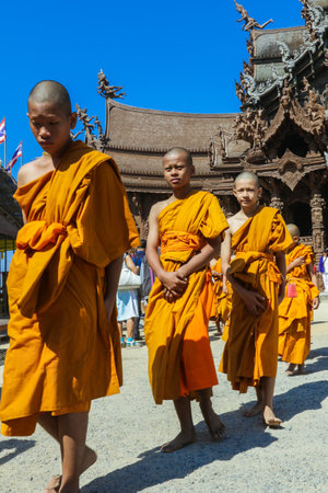 Pattaya, Thailand - March 25, 2022: Ceremonial Procession of the Young Monks in the traditional Orange Dressing in the Sanctuary of Truthのeditorial素材