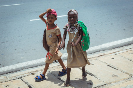 Lome, Togo - March 05, 2023: Two African Schoolgirls  are going home from the Lessonsのeditorial素材