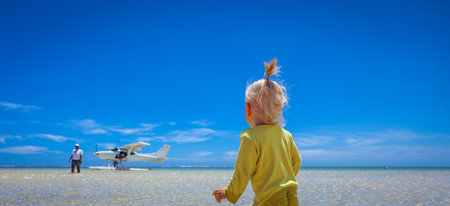 Little Girl Standing on Sandy Beach in Mauritiusの写真素材