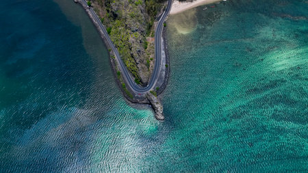Aerial View of Winding Road Leading Into the Oceanの写真素材