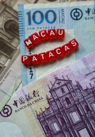 Two Red Pills on Pile of Macao Money Patacasの写真素材