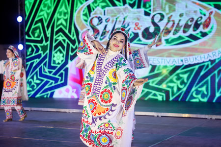 Bukhara, Uzbekistan - June 19, 2023: Woman in Colorful Dress on Stageのeditorial素材