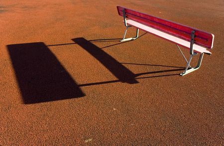 A red sports bench on red rubber trackの写真素材