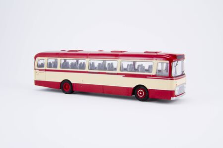 Red and cream single-deck model bus three quarter fron t view, isolated on white backgroundの写真素材