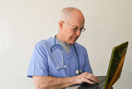 Doctor holding laptopの写真素材