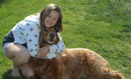teen girl hugging big red dog  1の写真素材