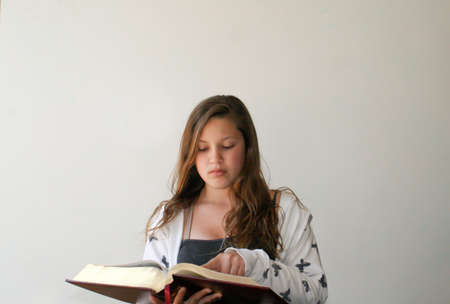 Teen girl reading bibleの写真素材