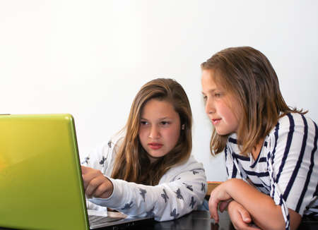 teen girls studying on laptopの写真素材