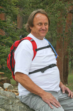 Happy resting male baby-boomer hikerの写真素材