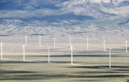 Nevada wind farm electrical generators shown with  electric towers and cars for scale