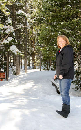 Senior female on snowy park trailの写真素材