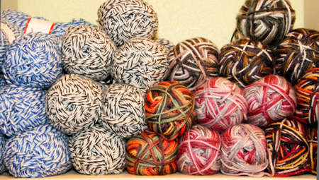 variegated yarn skeins stacked on display for saleの写真素材