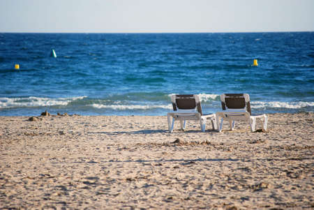 Dech chairs on the beachの写真素材