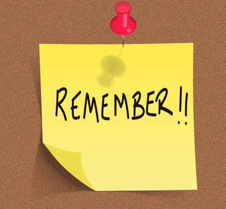 Yellow post-it on cork backgroundの写真素材