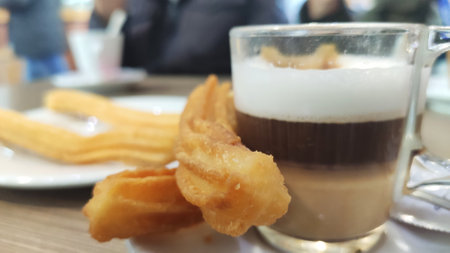 Traditional Spanish dessert churros with sugar and chocolate